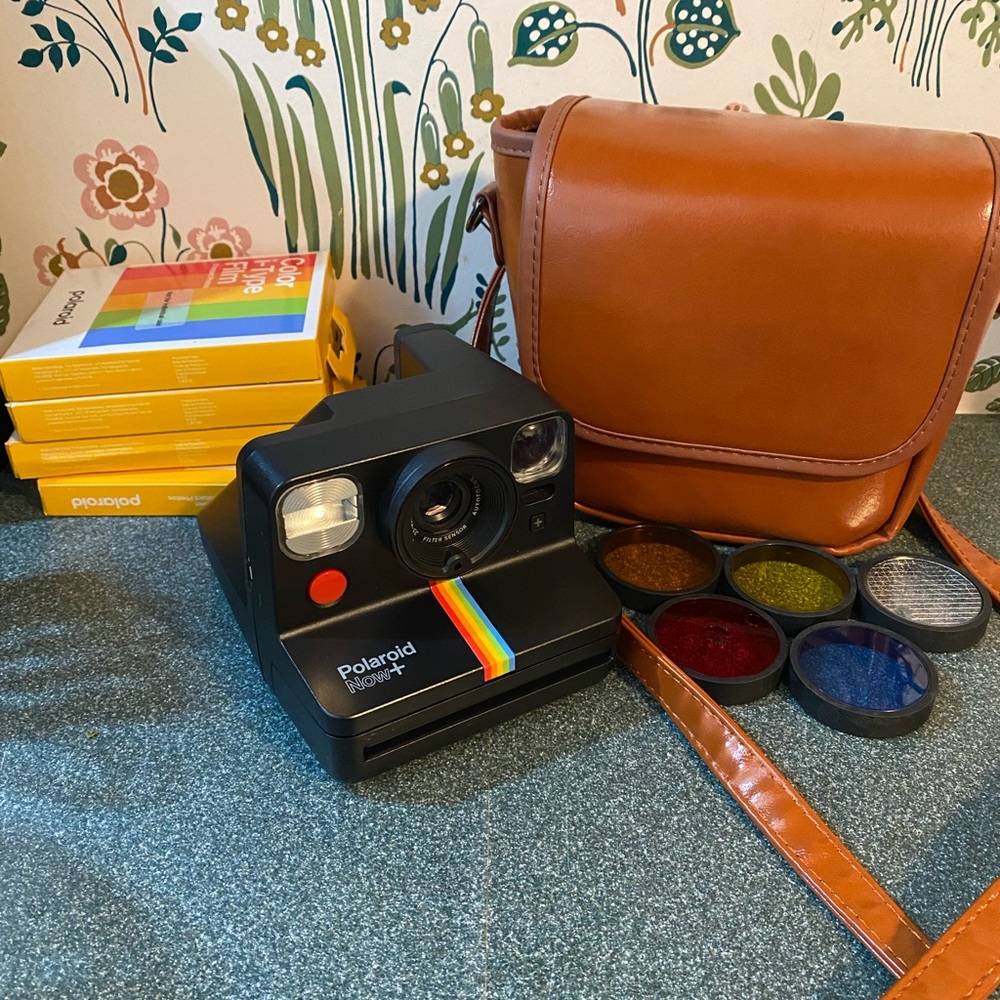 Black Polaroid Now+, includes film and leather carrying bag.